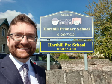 Alexander Stafford outside Harthill Primary School sign